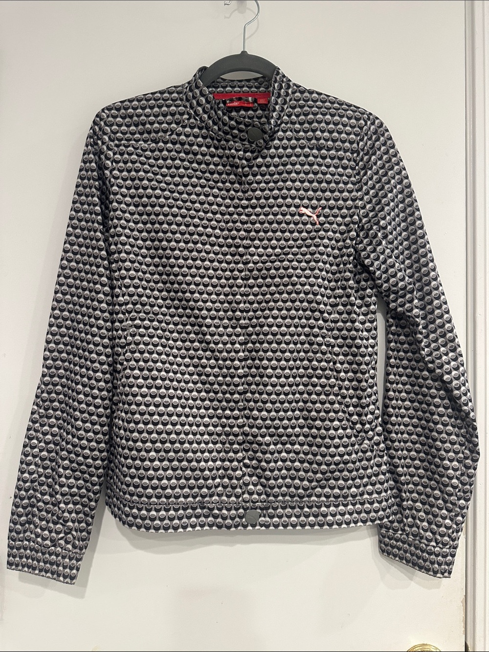 Puma Women’s Moto Windbreaker Jacket with golf ball print, size M.